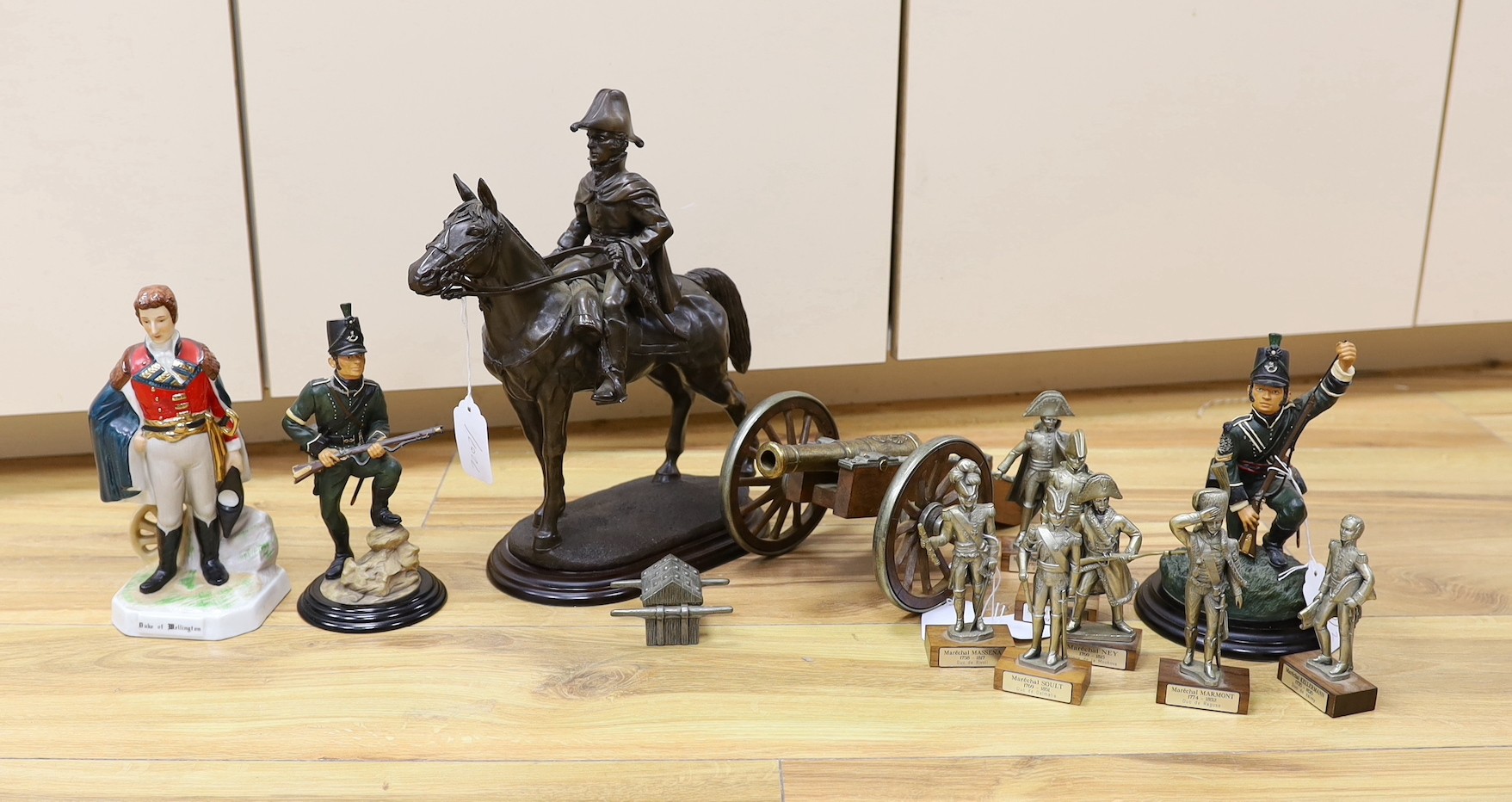 Duke of Wellington and Napoleonic war interest – a group of composition and ceramic figures of soldiers, a model of a cannon, a composition group of Wellington on horseback etc.